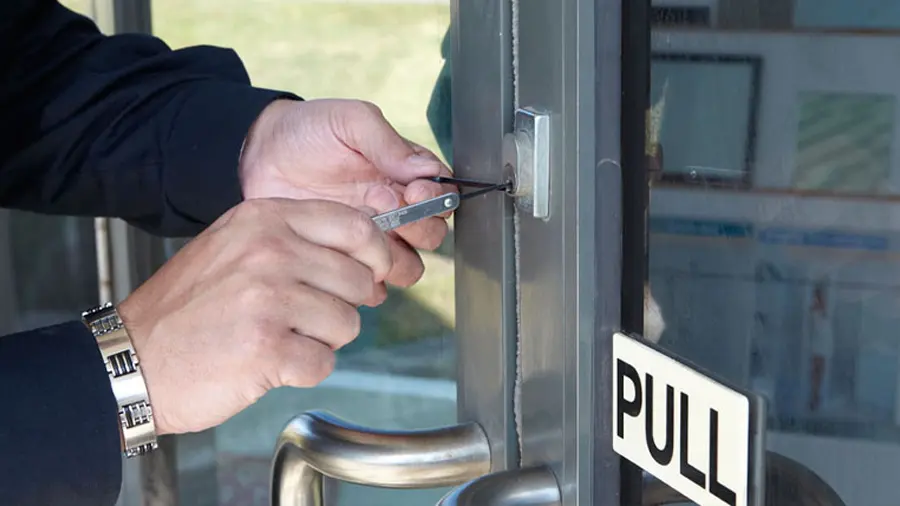 Commercial locksmith rekeying an office door lock in Austin, Texas