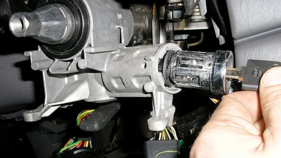 Locksmith repairing a car ignition and testing new keys in Austin, TX