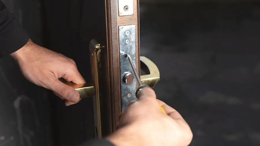 Locksmith rekeying home door locks for a homeowner in Austin, TX